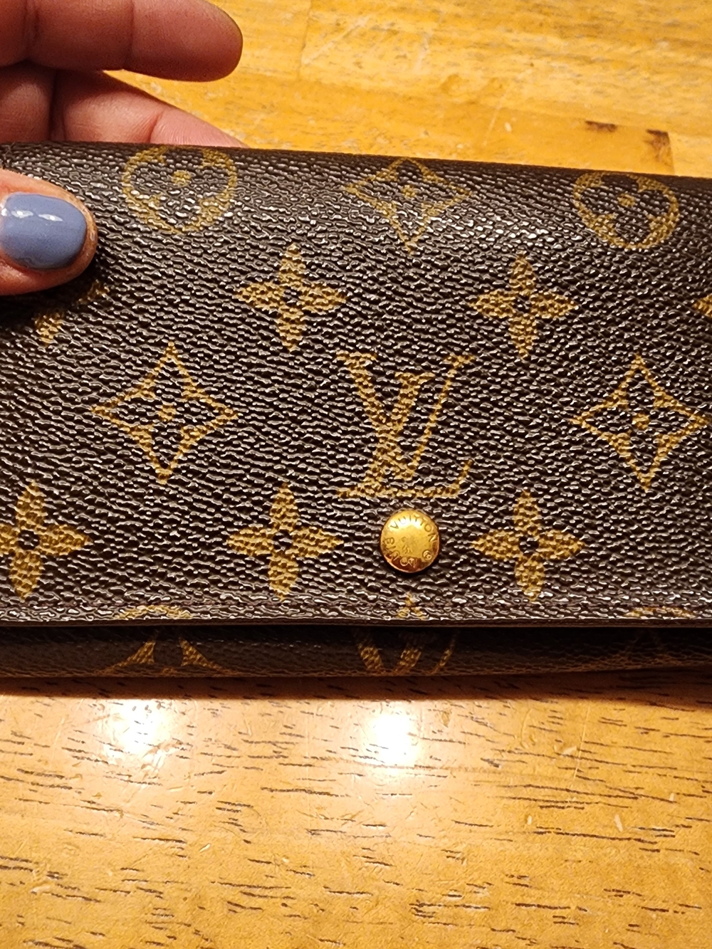 This is a Louis Vuitton Monogram Porte-Monnaie Tresor wallet